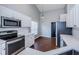 Stylish kitchen featuring modern appliances, white cabinetry, and stainless steel microwave at 5627 War Admiral Dr, Wesley Chapel, FL 33544