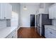 Modern kitchen featuring stainless steel appliances, sleek countertops, and wood flooring at 5627 War Admiral Dr, Wesley Chapel, FL 33544