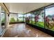 Screened-in lanai featuring tile flooring and views of the landscaped backyard at 5627 War Admiral Dr, Wesley Chapel, FL 33544