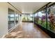 Spacious tiled lanai offering serene backyard views through screened enclosure at 5627 War Admiral Dr, Wesley Chapel, FL 33544