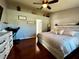 Main bedroom features a king bed, a dresser, and a view of a partial loft area at 5627 War Admiral Dr, Wesley Chapel, FL 33544