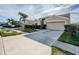 A beautifully landscaped home with a wide driveway and well-maintained yard, offering curb appeal at 5627 War Admiral Dr, Wesley Chapel, FL 33544