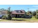 House exterior with a dark-colored door, a small porch, and a fenced yard at 5901 S 6Th St, Tampa, FL 33611