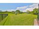 Large backyard with lush grass and pond view at 6836 Park Strand Dr, Apollo Beach, FL 33572