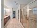 Large bathroom with double vanity, walk-in shower, and tile flooring at 6836 Park Strand Dr, Apollo Beach, FL 33572