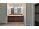 Bathroom with double vanity and dark wood cabinets at 6836 Park Strand Dr, Apollo Beach, FL 33572