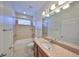 Clean bathroom with tub, shower, and granite vanity at 6836 Park Strand Dr, Apollo Beach, FL 33572