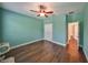 Spacious bedroom with wood-look floors and access to hallway at 6836 Park Strand Dr, Apollo Beach, FL 33572