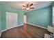 Light and airy bedroom with wood-look floors and double doors at 6836 Park Strand Dr, Apollo Beach, FL 33572