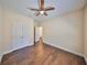 Bright bedroom with hardwood floors and access to bathroom at 6836 Park Strand Dr, Apollo Beach, FL 33572