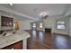 Open living space with hardwood floors and kitchen island view at 6836 Park Strand Dr, Apollo Beach, FL 33572