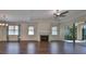 Living room with hardwood floors, fireplace, and sliding glass doors at 6836 Park Strand Dr, Apollo Beach, FL 33572