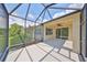 Enjoyable screened porch with view of backyard and pond at 6836 Park Strand Dr, Apollo Beach, FL 33572