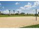 Sand volleyball court with net and surrounding grassy area at 6836 Park Strand Dr, Apollo Beach, FL 33572