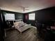 Bedroom with dark walls, a bed, and gaming chairs at 1104 Winchester N Rd, St Petersburg, FL 33710