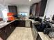 Well-equipped kitchen with dark wood cabinets and granite counters at 1104 Winchester N Rd, St Petersburg, FL 33710