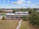 An aerial view of a house with a curved walkway, lush lawn, and solar panels at 1308 Ivywood Dr, Brandon, FL 33510