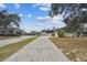 Long driveway leading to a two-story house with attached garage at 1308 Ivywood Dr, Brandon, FL 33510