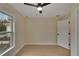 Spacious bedroom with wood-look floors, ceiling fan, and window at 14813 Oak Vine Dr, Lutz, FL 33559