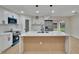 Modern kitchen island with white quartz countertops and wood accents at 14813 Oak Vine Dr, Lutz, FL 33559