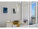 Bright dining area featuring a glass-topped table, modern chandelier, and view of the ocean at 175 2Nd S St # P-08, St Petersburg, FL 33701