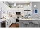 Beautiful kitchen with white cabinets, marble countertops, and modern appliances at 175 2Nd S St # P-08, St Petersburg, FL 33701