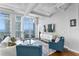 A cozy living room with ample light, stylish furniture and decor, and sliding glass doors leading to a balcony at 175 2Nd S St # P-08, St Petersburg, FL 33701