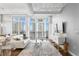 Living area featuring large windows, balcony access with views, and modern decor and furnishings at 175 2Nd S St # P-08, St Petersburg, FL 33701