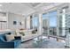 Bright living space featuring an open floor plan, modern furnishings, and balcony access with stunning ocean views at 175 2Nd S St # P-08, St Petersburg, FL 33701