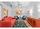 Cozy living room with a bright red sofa, blue chairs, and unique decor at 175 2Nd S St # P-08, St Petersburg, FL 33701
