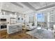 Bright living space featuring an open floor plan, modern furnishings, and balcony access with stunning ocean views at 175 2Nd S St # P-08, St Petersburg, FL 33701