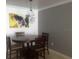 Dining table with four chairs, geometric light fixture, and modern wall art at 18235 Bridle Club Dr # 18235, Tampa, FL 33647