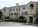 Tan-colored multi-unit residential building with parking and landscaping at 18235 Bridle Club Dr # 18235, Tampa, FL 33647
