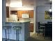 Kitchen with breakfast bar, light wood cabinets and small table at 18235 Bridle Club Dr # 18235, Tampa, FL 33647