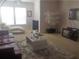 Living room with white coffee table, red couch, and chaise lounge at 18235 Bridle Club Dr # 18235, Tampa, FL 33647