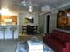 Open concept living and dining area with red couch and kitchen view at 18235 Bridle Club Dr # 18235, Tampa, FL 33647