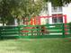 Community playground with green and red equipment at 18235 Bridle Club Dr # 18235, Tampa, FL 33647