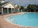 Community pool with surrounding patio and lounge chair at 18235 Bridle Club Dr # 18235, Tampa, FL 33647