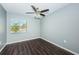 Well-lit bedroom with dark laminate flooring and window at 1881 N Hercules Ave # 803, Clearwater, FL 33765