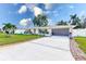 Single story home with attached garage and landscaped lawn at 2019 Magnolia Dr, Clearwater, FL 33764