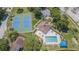 Aerial view showing tennis courts, pool, and clubhouse at 21550 Clubside Loop, Lutz, FL 33549