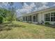Lush green backyard with screened lanai view at 21550 Clubside Loop, Lutz, FL 33549
