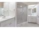 Bathroom featuring a walk-in shower, dual vanities, and great natural light at 21550 Clubside Loop, Lutz, FL 33549