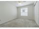 Cozy bedroom with neutral carpet, ceiling fan, and a window for natural light at 21550 Clubside Loop, Lutz, FL 33549