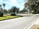 Landscaped entrance to community with tennis courts and mailbox area at 21550 Clubside Loop, Lutz, FL 33549