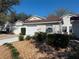 Charming one-story townhome with a well-maintained front yard and attached garage at 21550 Clubside Loop, Lutz, FL 33549