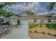 Charming townhome with neutral siding, a well-manicured lawn and a private one-car garage at 21550 Clubside Loop, Lutz, FL 33549