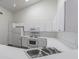 Bright kitchen with white cabinets, appliances, and countertops, plus a stainless steel sink at 21550 Clubside Loop, Lutz, FL 33549