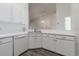 Bright kitchen features white cabinets and sleek countertops at 21550 Clubside Loop, Lutz, FL 33549
