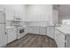 Bright kitchen features white cabinets, modern appliances, and sleek countertops at 21550 Clubside Loop, Lutz, FL 33549